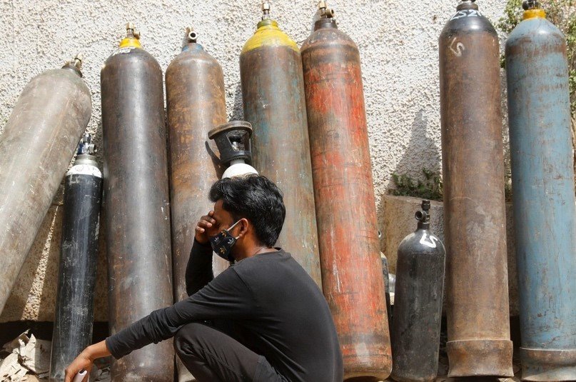 A man waits outside a factory to get his oxygen cylinder refilled, amidst the spread of the coronavirus disease in New Delhi, India, April 28, 2021.